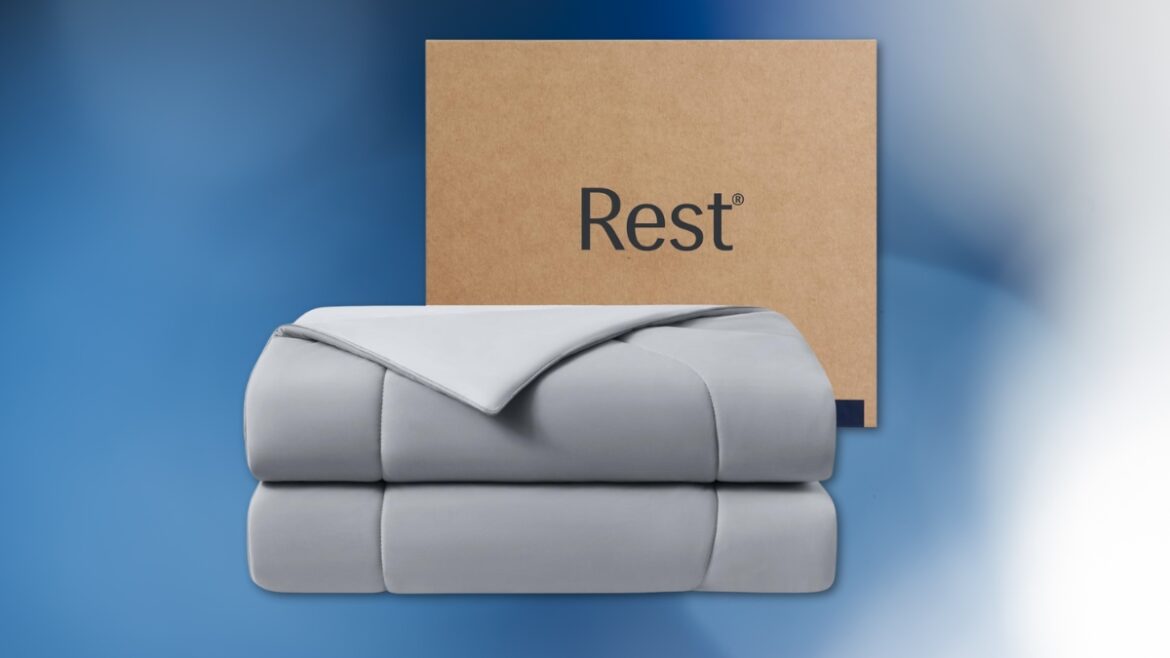 Soft gray REST Evercool Cooling Comforter folded neatly in front of a Rest branded box.