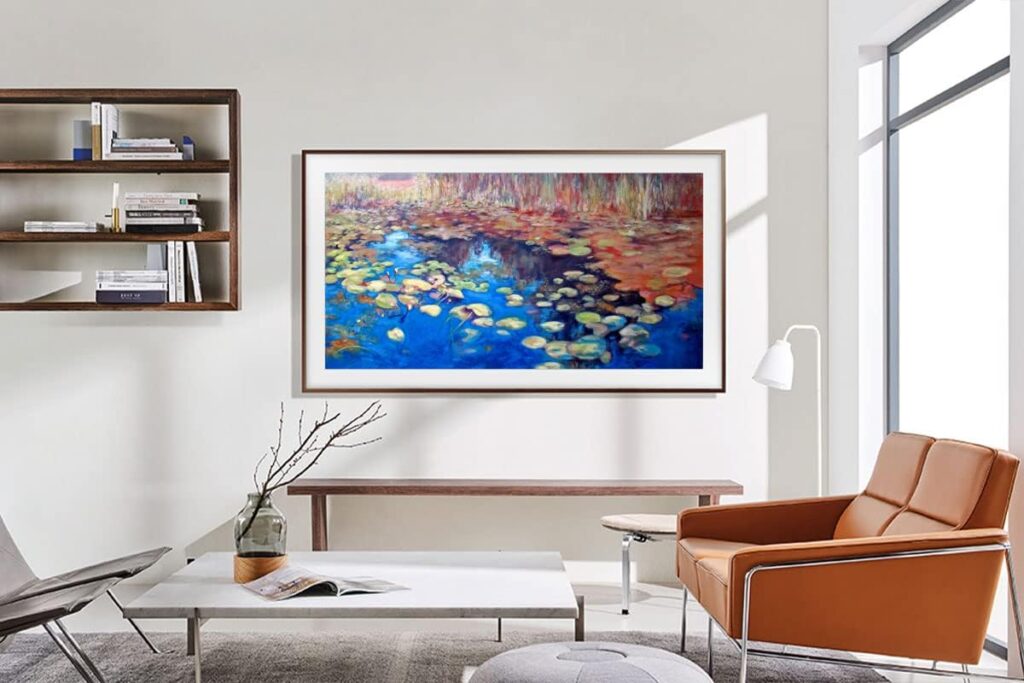 Modern living room with Samsung The Frame TV displaying a colorful water lily painting, surrounded by minimalist furniture and natural light.