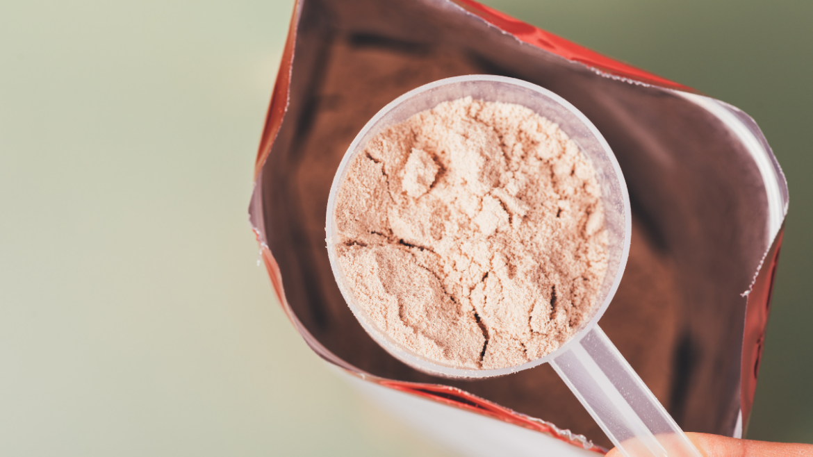 Scoop of protein supplement powder inside an open pouch for fitness and nutrition support.